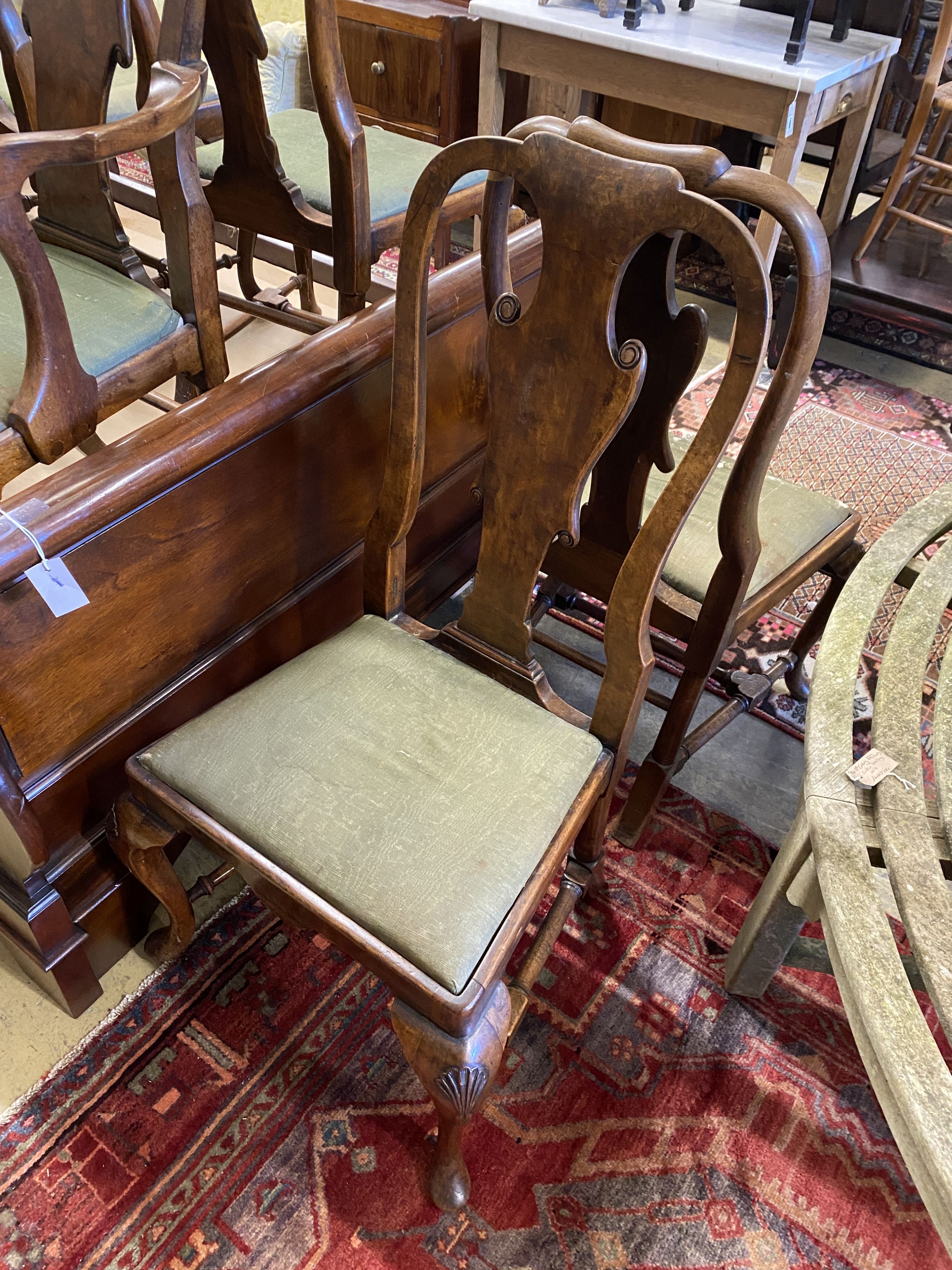 A set of eight George I style walnut dining chairs, two with arms.